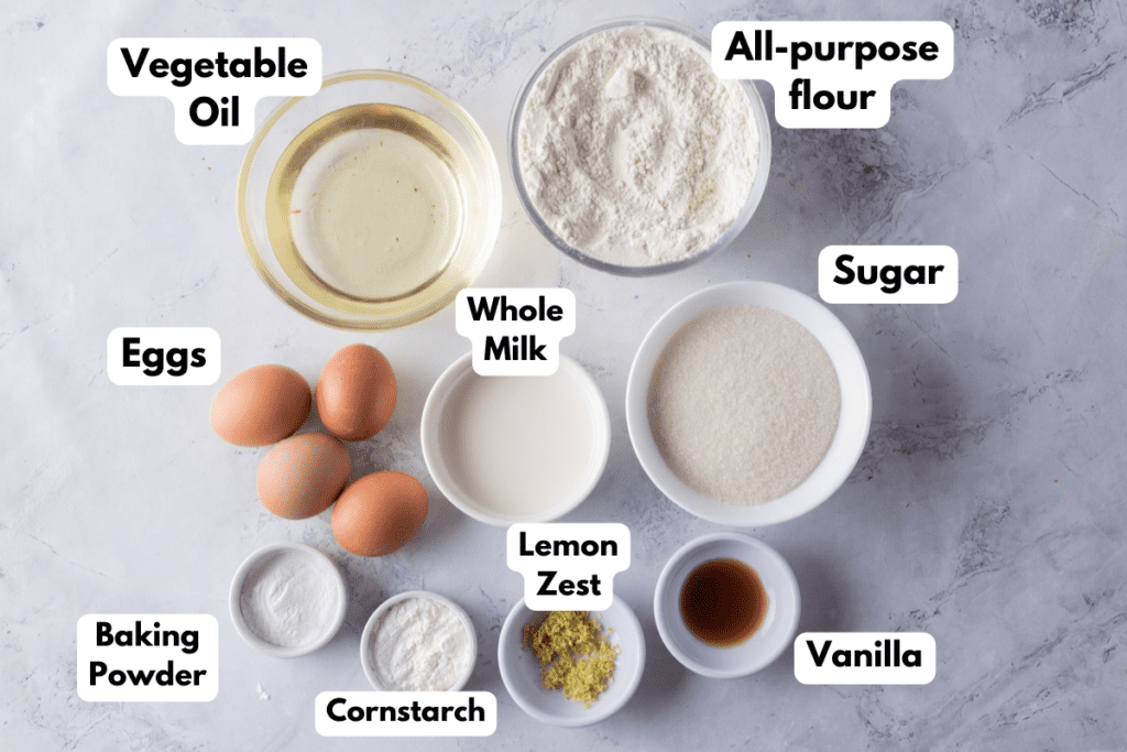 The ingredients needed to make the cake batter labeled and sitting on a white marble surface.