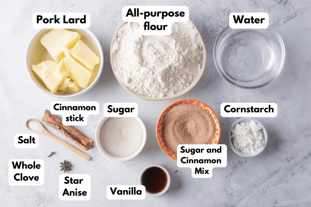 The ingredients needed to make Pan de Polvo labeled and sitting on a white marble surface.