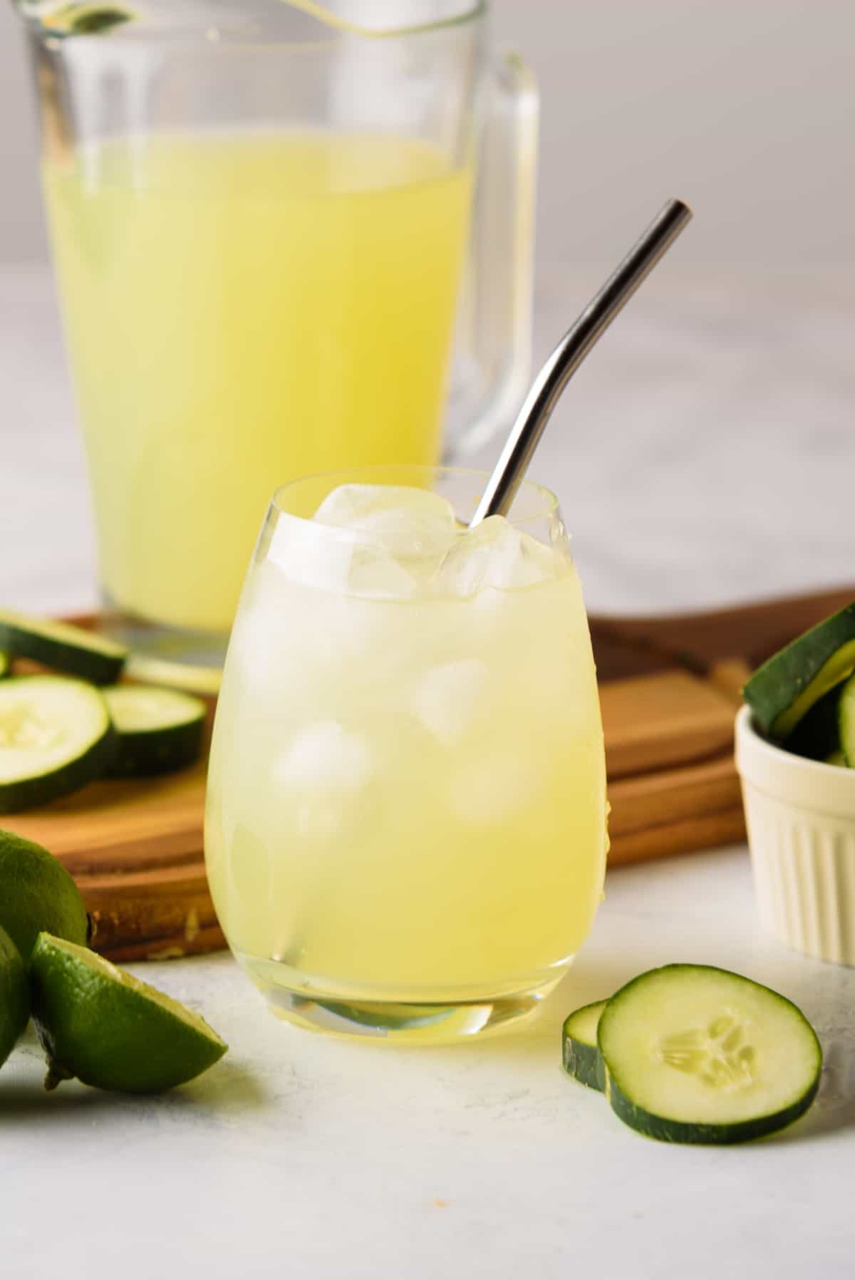Cucumber Agua Fresca served in a glass with ice and a metal straw.