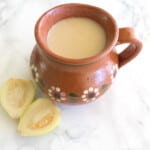 Atole de guayaba served in a decorative Mexican clay mug.