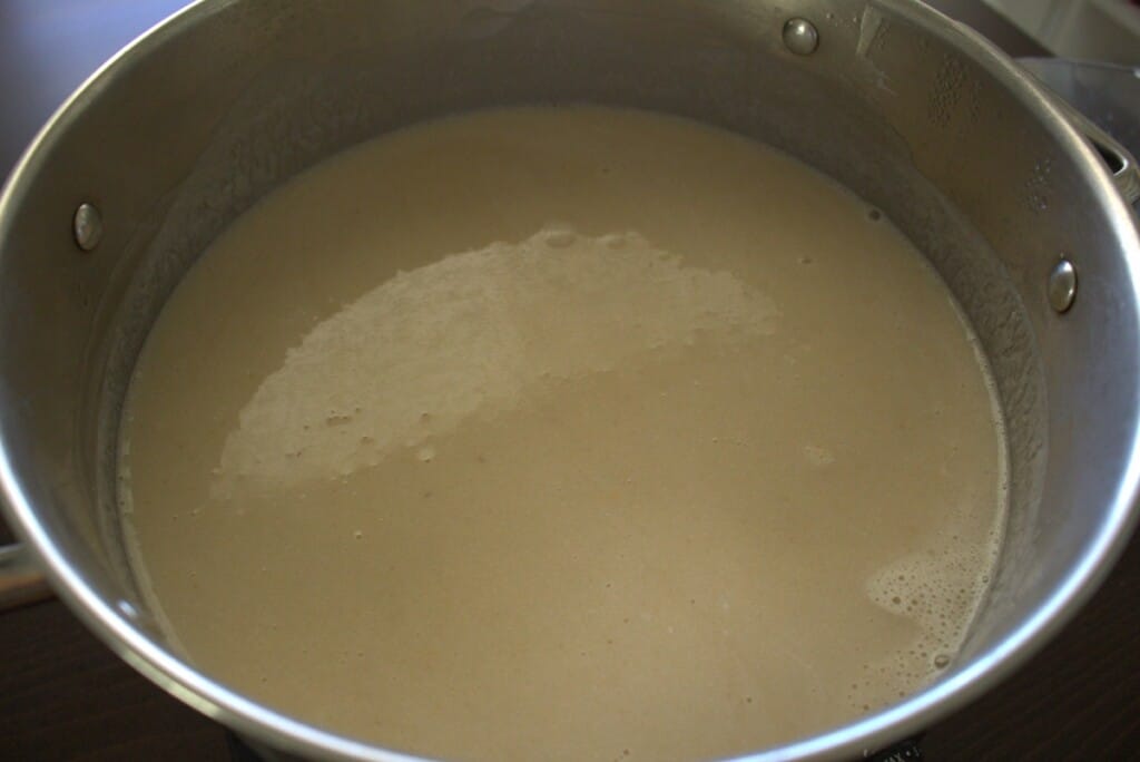 A stockpot with guava atole bubbling.