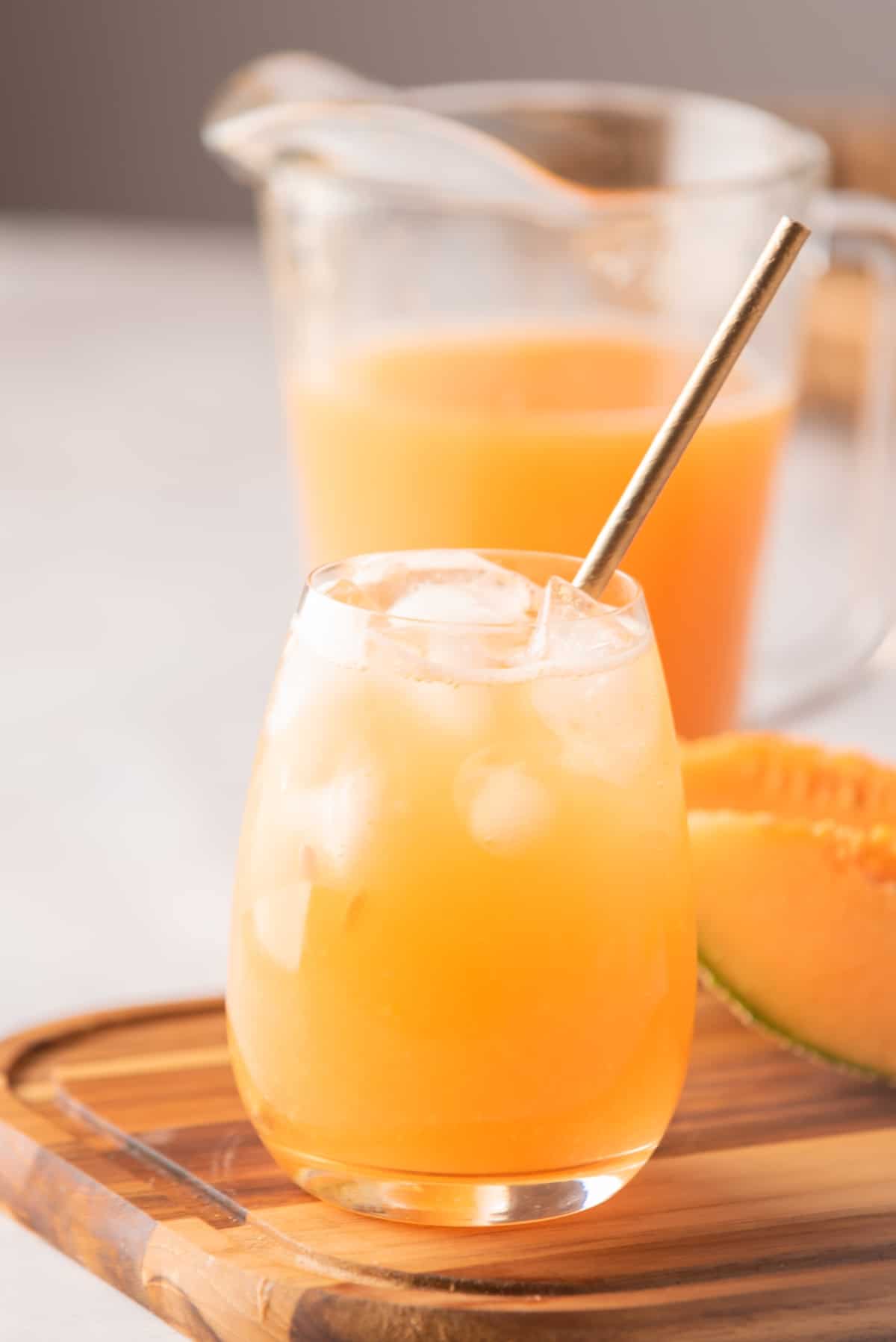 Cantaloupe Agua Fresca served with ice in a glass.