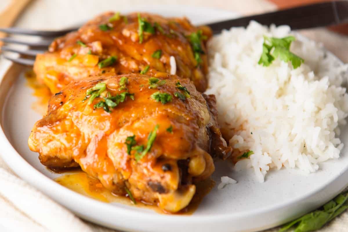 Coca Cola Chicken served with white rice in a large plate.