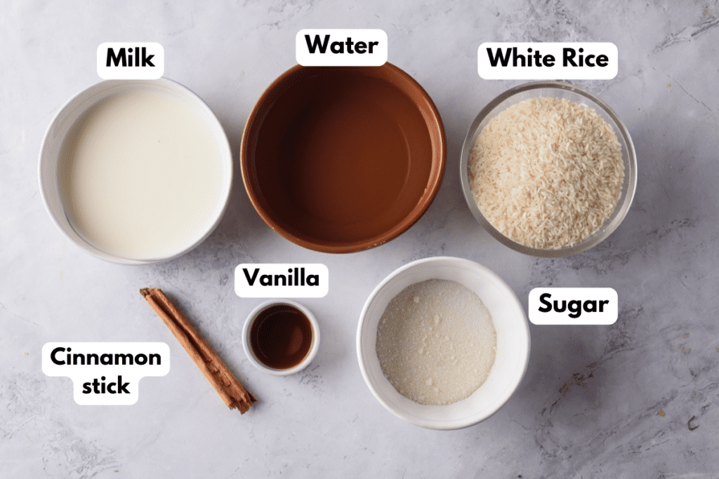 The ingredients needed to make horchata labeled and sitting on a marble surface.
