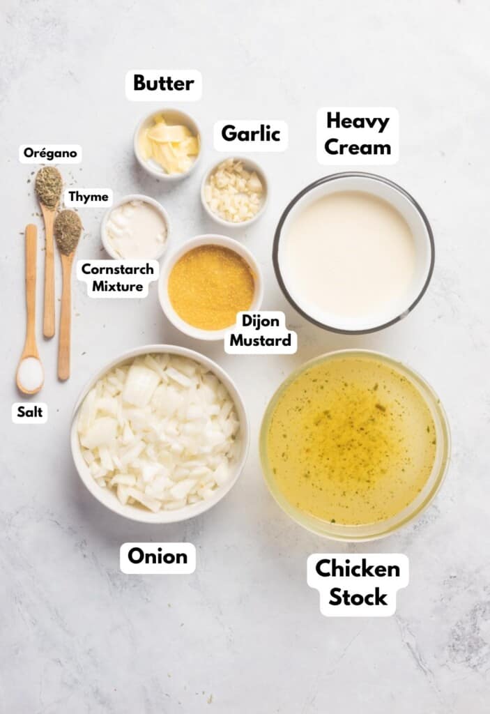 The ingredients needed to make the mustard sauce for the mustard chicken labeled and sitting on a white marble surface.