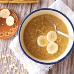 A bowl of avena (or Mexican oatmeal) topped with sliced bananas.
