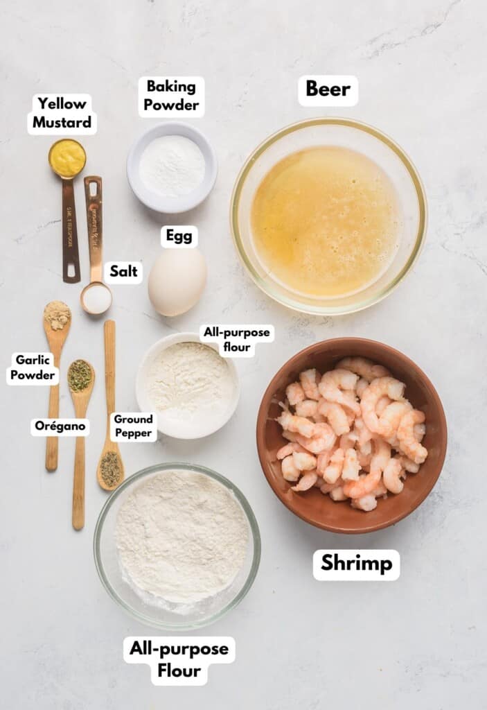 The ingredients needed to make the batter for the shrimp tacos labeled and sitting on a marble surface.