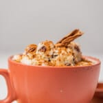 Arroz con Leche served in a cup and topped with cinnamon.