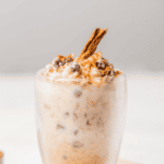 Mexican Arroz con Leche served in a glass and garnished with a cinnamon stick.
