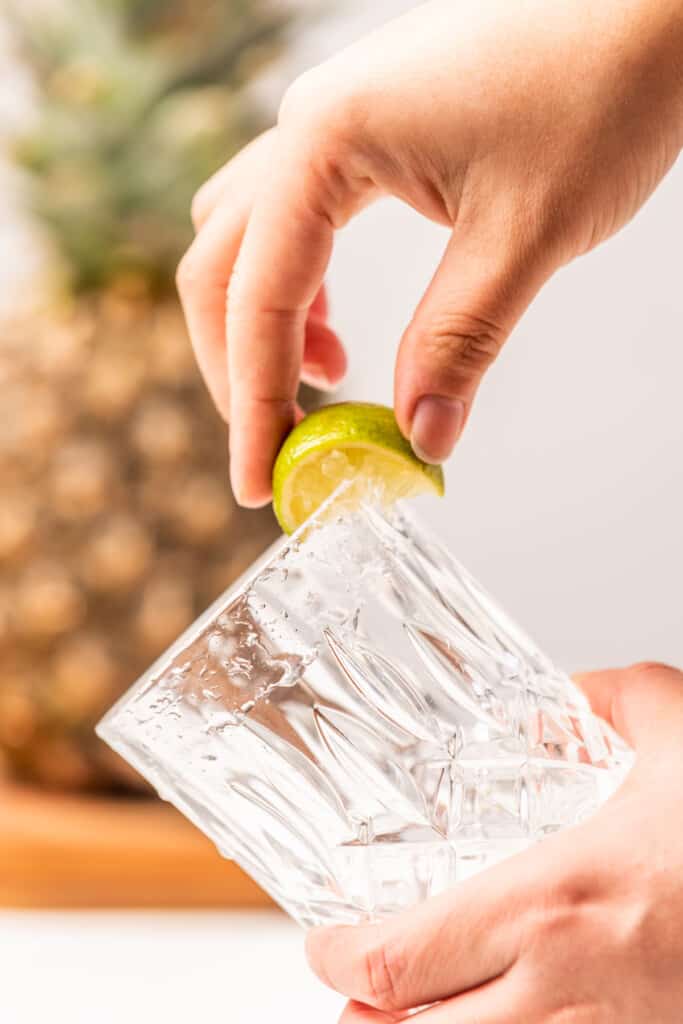 Rubbing the rim of the glass with a lime