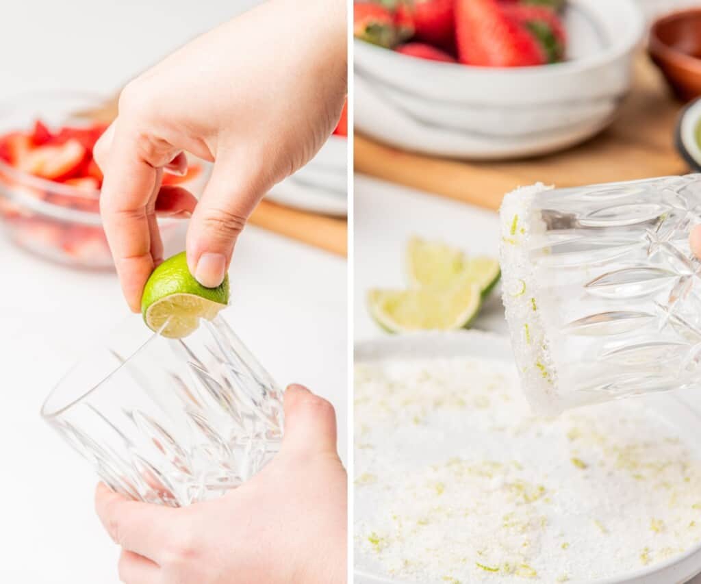 A hand rubbing lime on the rim of a glass and dipping it into salt.