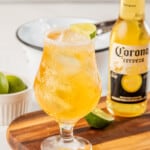 A Mexican beer cocktail served next to a Corona beer bottle.