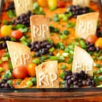 The Halloween Taco Dip served in a baking dish.