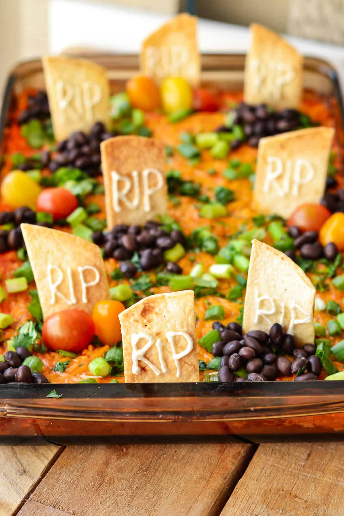 The Halloween Taco Dip served in a baking dish.