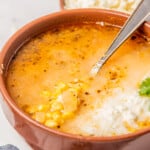 Sopa de Elote served in a bowl with a spoon.