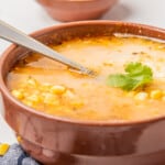 Sopa de Elote topped with cheese and cilantro.