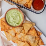 Mexican tortilla chips (or totopos) served with guacamole and tomato salsa.