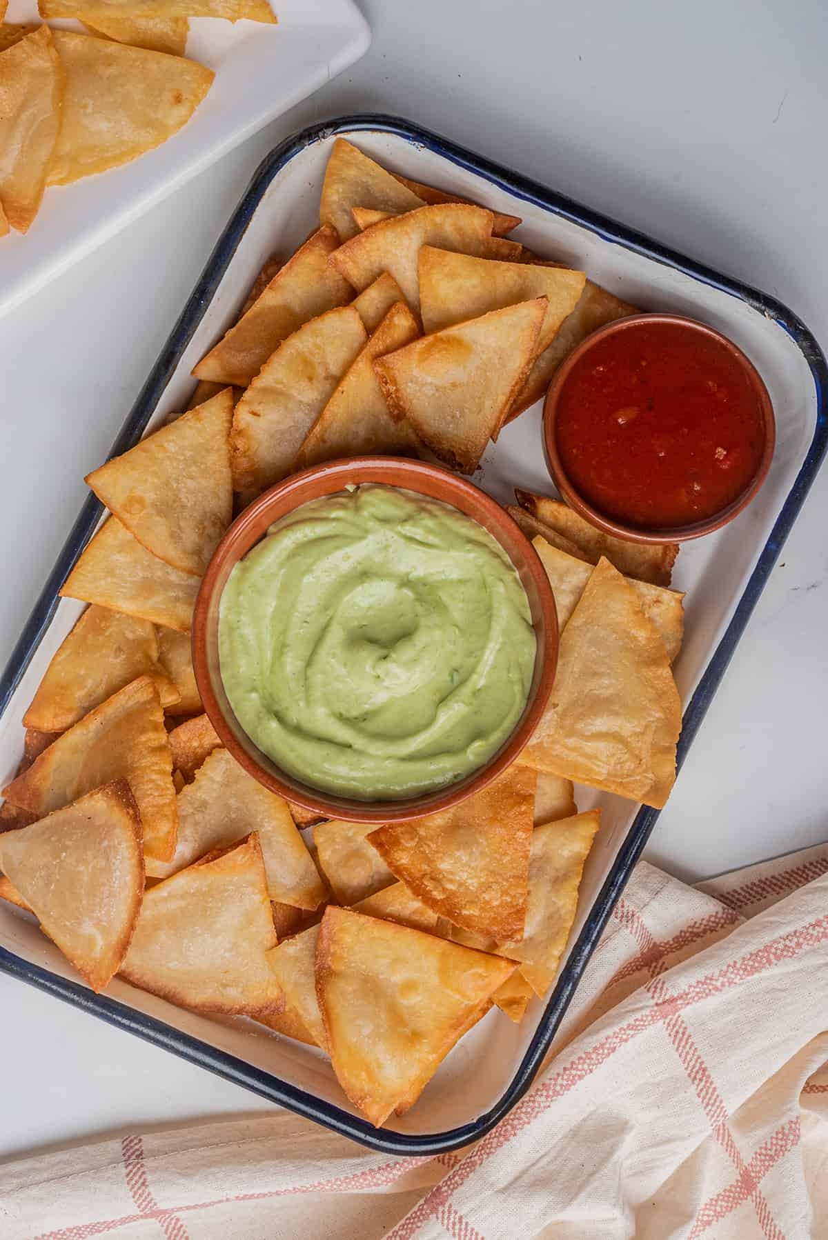Mexican tortilla chips served with guacamole and salsa.