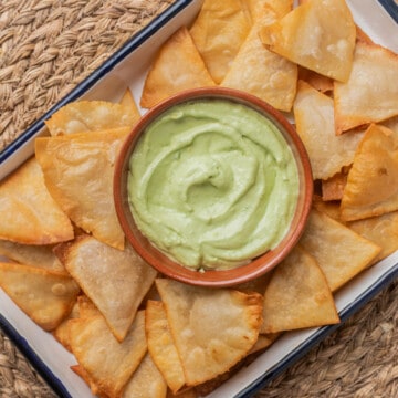 Totopos (or Mexican tortilla chips) served with guacamole.