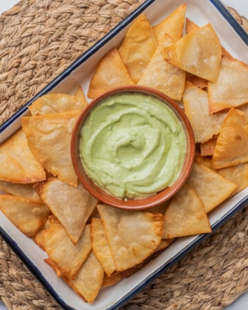 Totopos (or Mexican tortilla chips) served with guacamole.