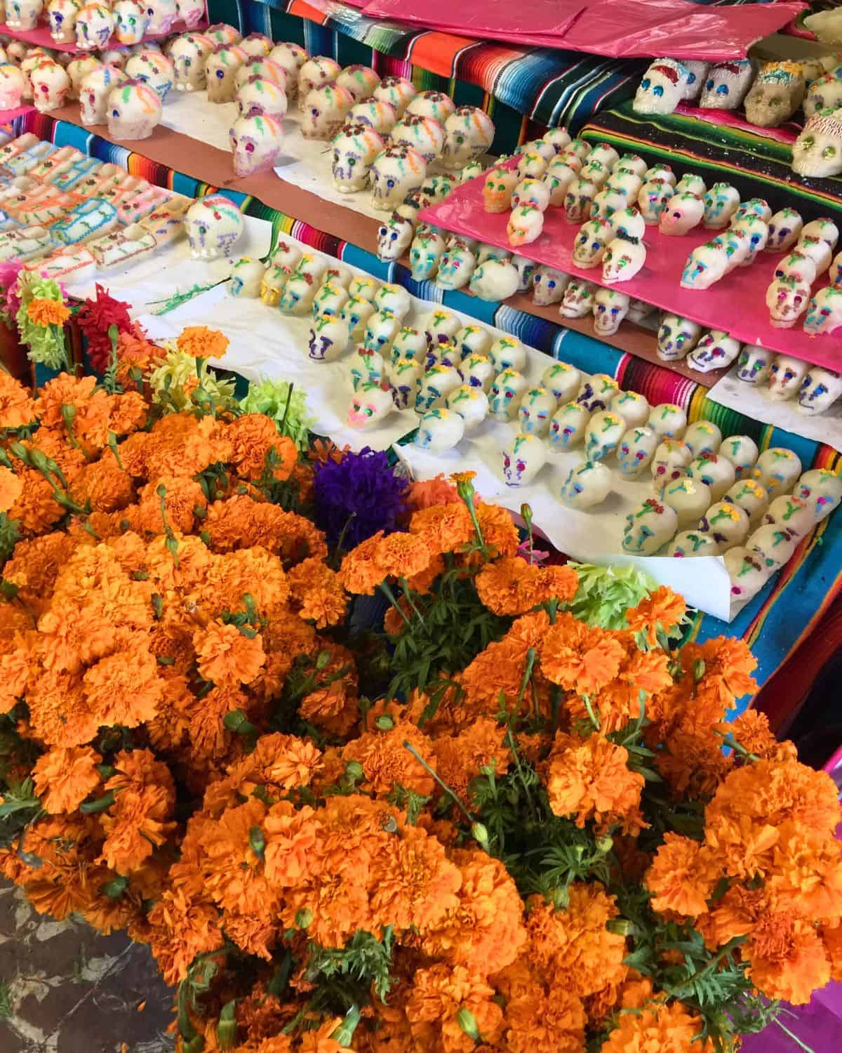 Marigolds and sugar skulls sold at a Mexican market.