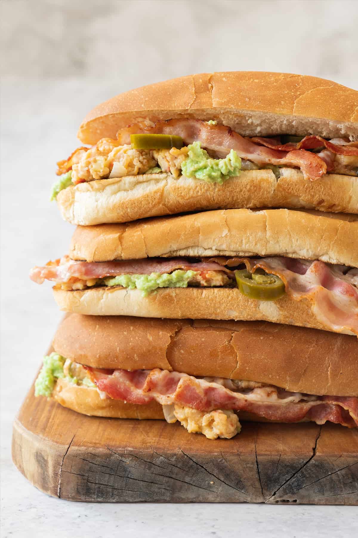 Three Mexican Breakfast Tortas stacked on top of each other.
