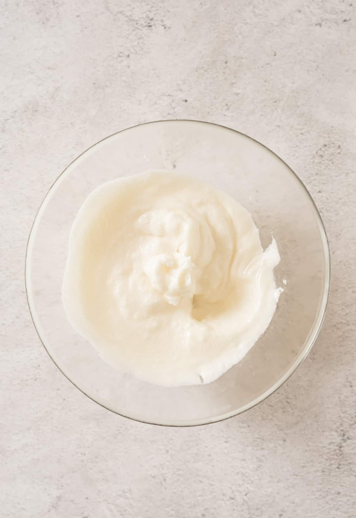 Lard creamed in a large glass bowl.