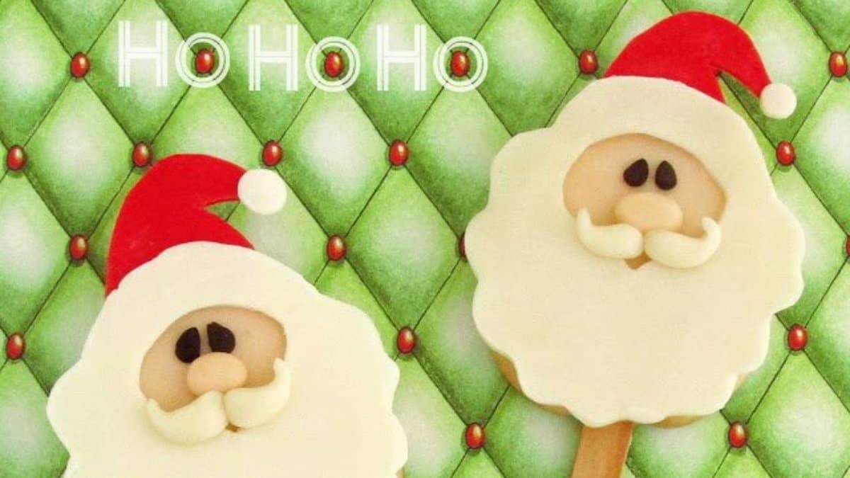 Two festive treats shaped like Santa Claus faces with red hats and white beards are displayed against a green, diamond-patterned holiday background with "Ho Ho Ho" written at the top.