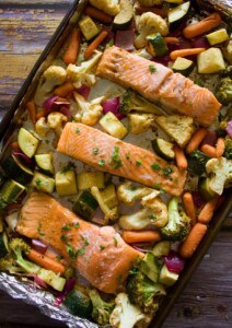 A sheet pan with baked salmon and vegetables.