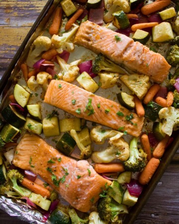 A sheet pan with baked salmon and vegetables.