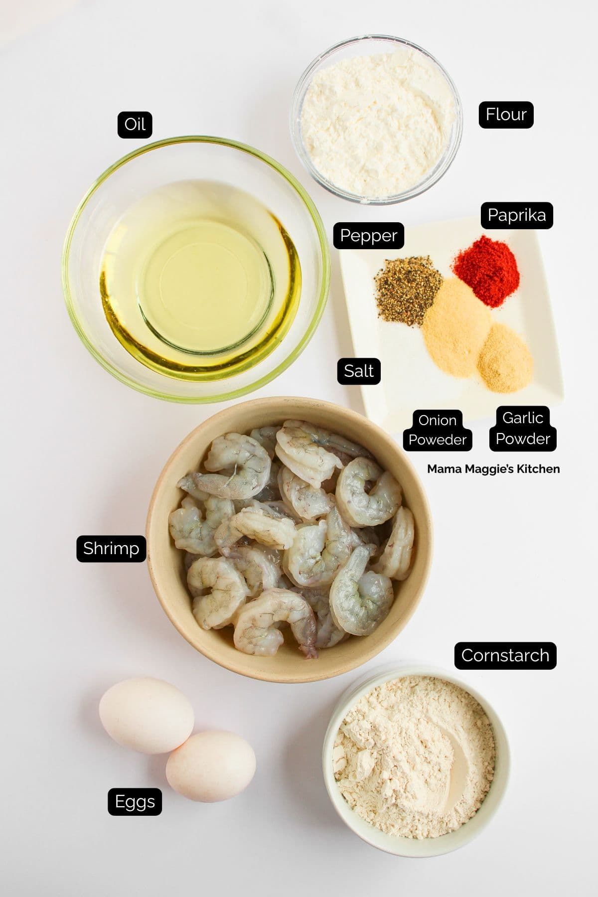 Top-down view of Bang Bang Shrimp Tacos ingredients: a bowl of oil, raw shrimp, two eggs, cornstarch, flour, and a plate with paprika, pepper, salt, onion powder, and garlic powder.